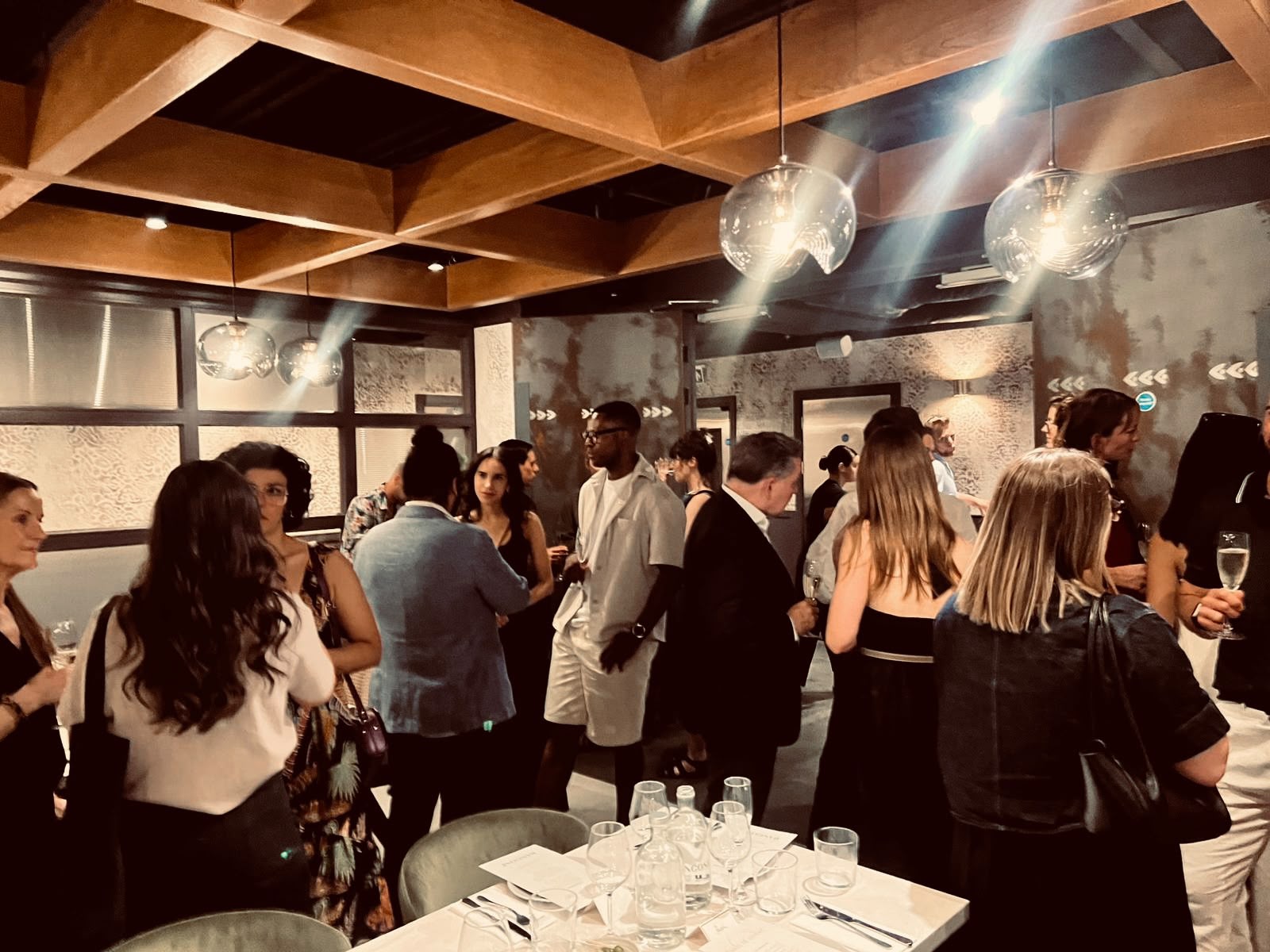 Guests seated along the Supper Club table