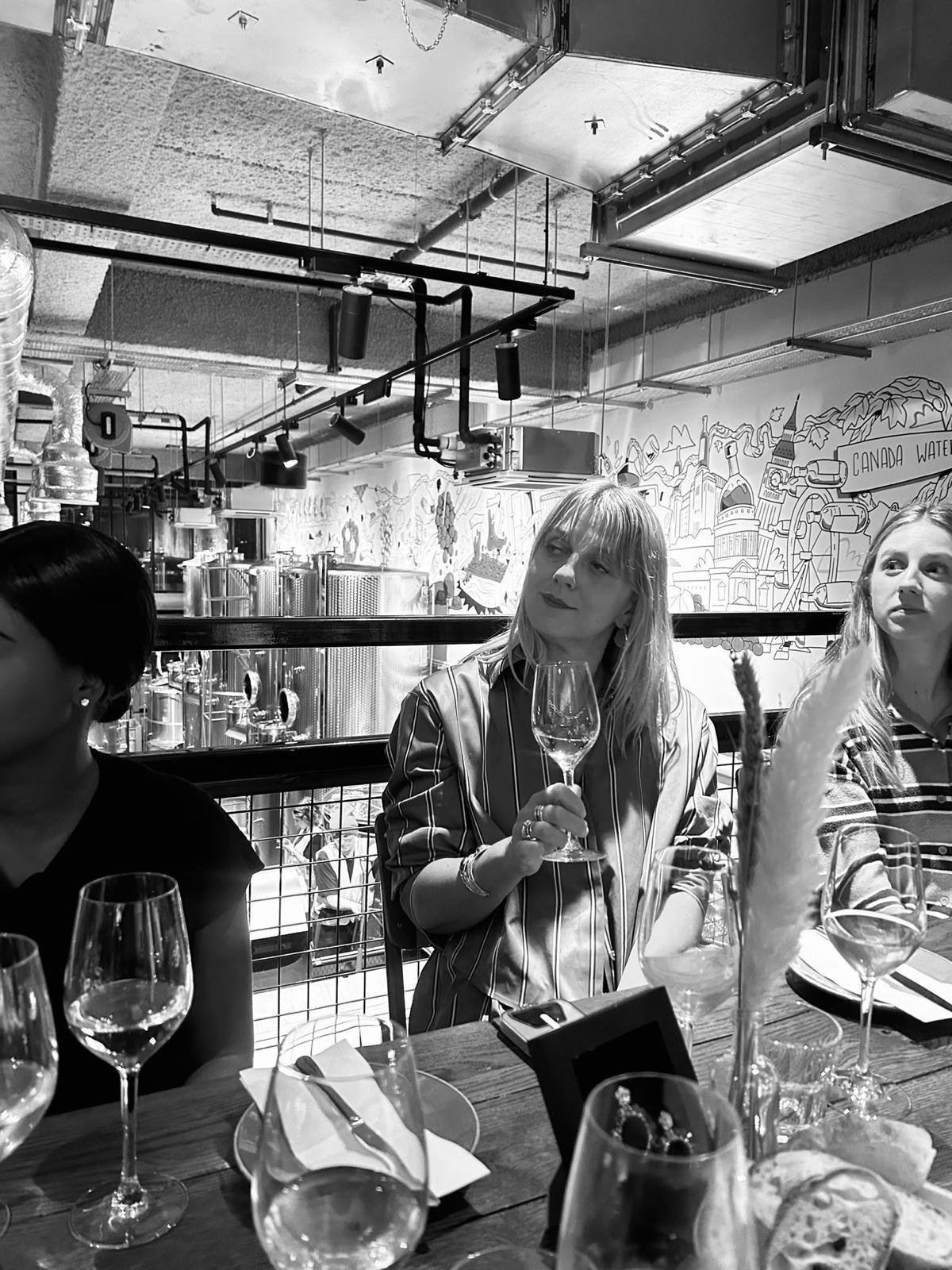 Guests listening over dinner at the Supper Club