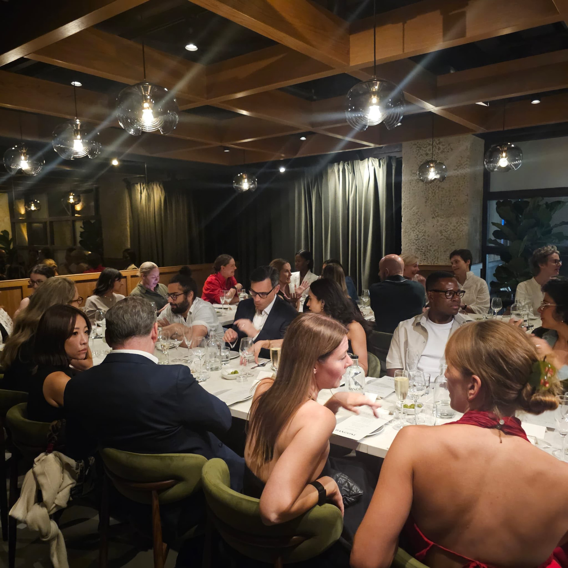 Guests in conversation over welcome drinks