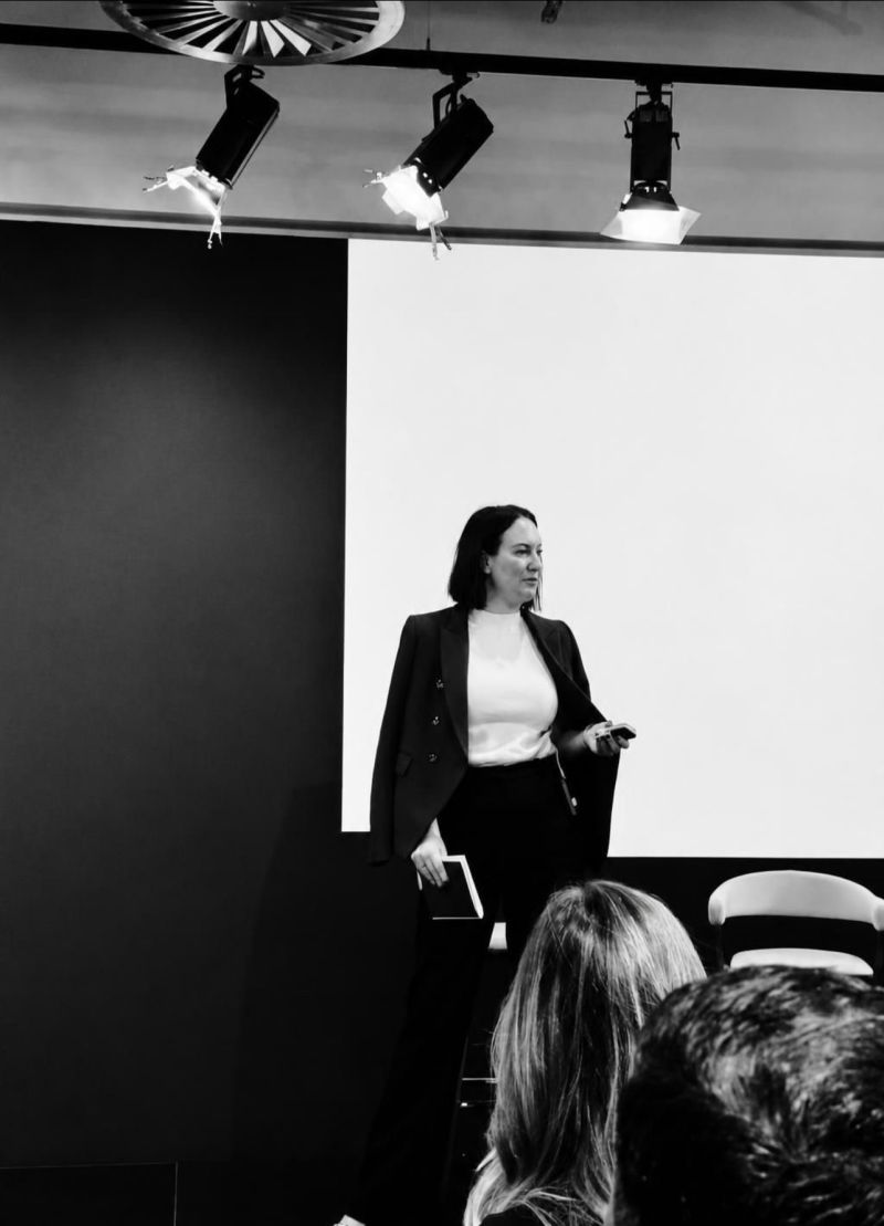Liz Wilch delivering a keynote to a seated audience